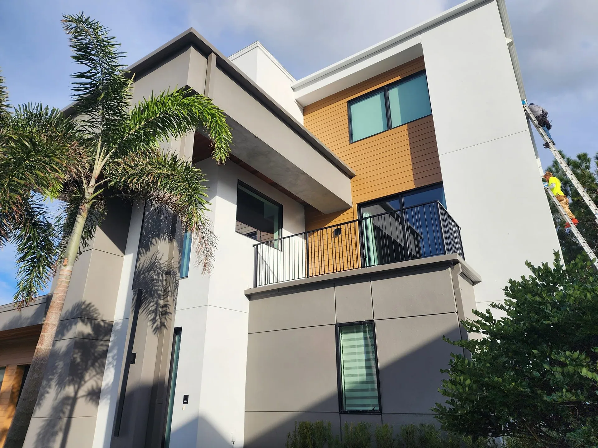 Workers ladder right side modern stucco wood accent balcony palm, Lake Mary